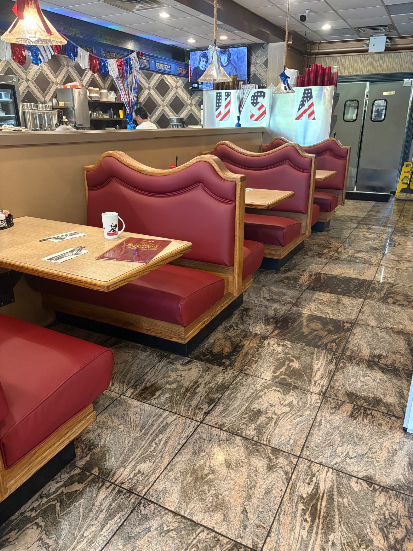 Classic red booths lined along the dining room